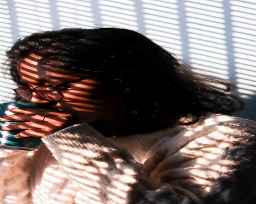 A person taking a comfortable break with a cup of tea in a sunlit Indian home
